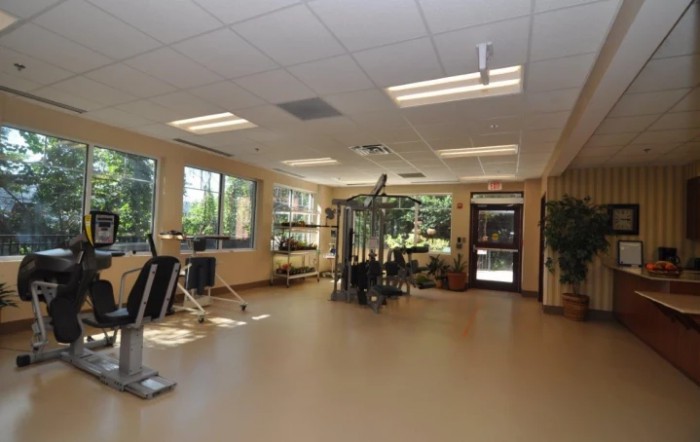 A spacious gym filled with exercise equipment and cardio machines.
