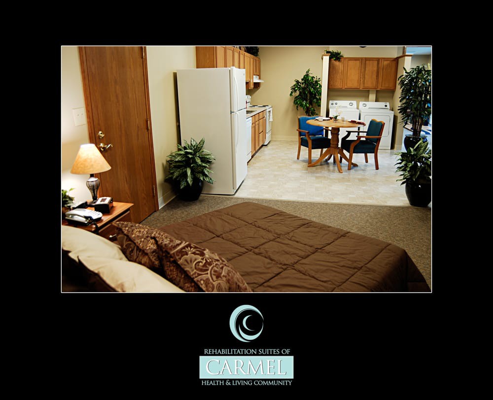 A cozy studio apartment featuring a bed, kitchenette, and dining area.