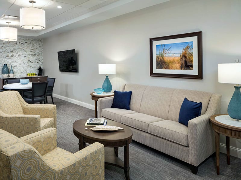 A modern living room with a comfortable sofa, armchairs, and stylish decor.