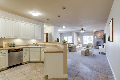 A spacious and inviting open-concept kitchen and living room, featuring modern appliances and neutral decor.