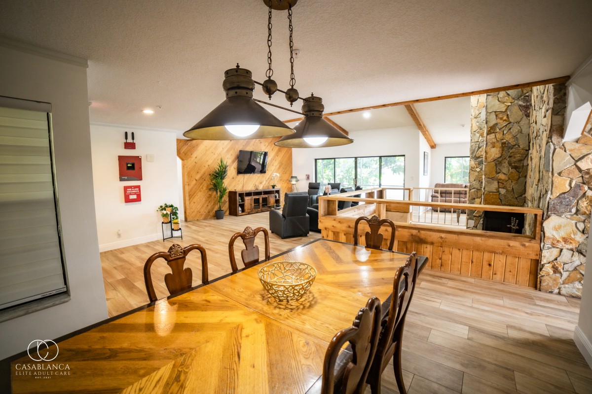 A cozy open-concept dining and living area featuring wooden furniture and a warm atmosphere.