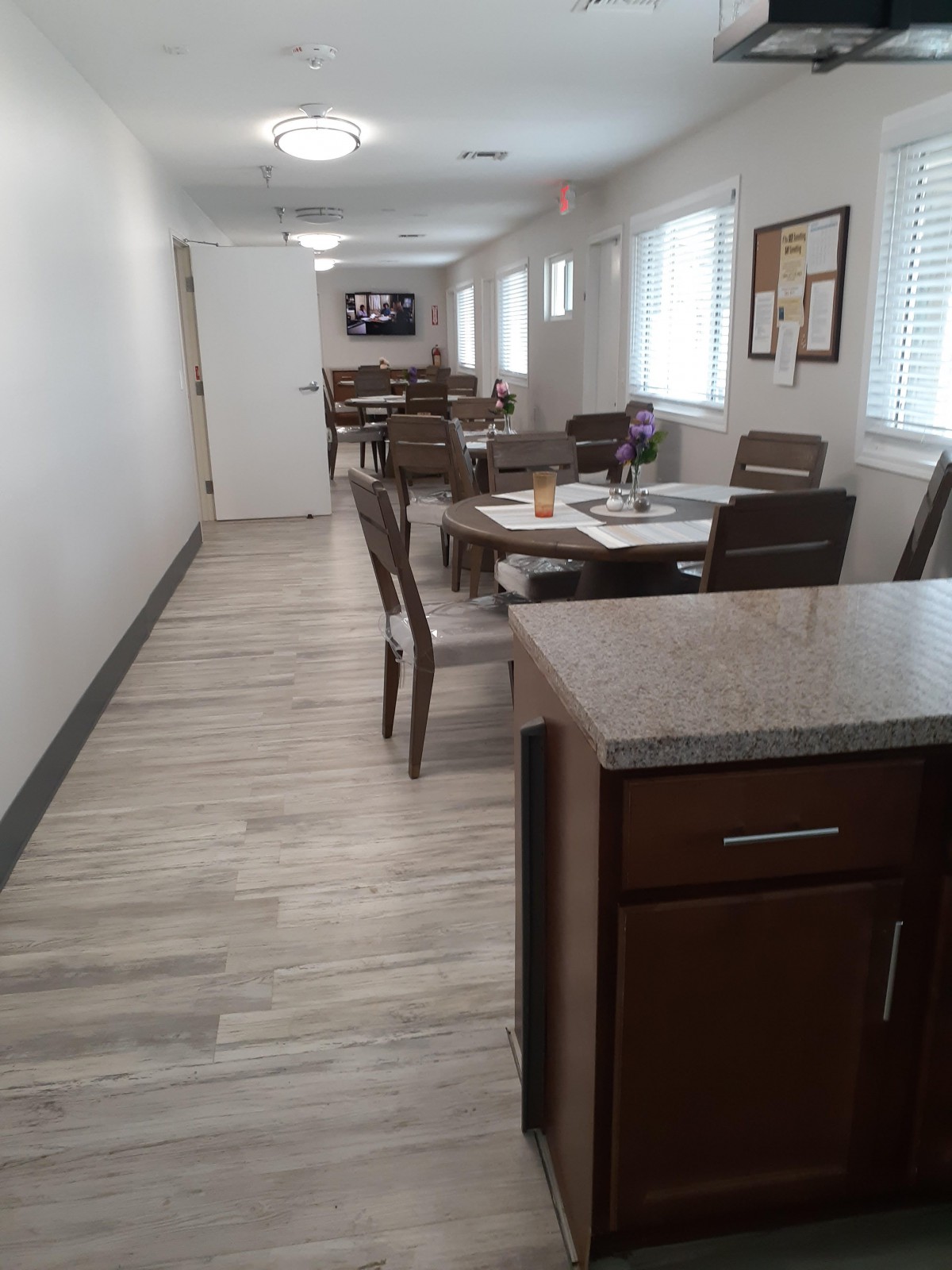 A modern dining area with neatly arranged tables and chairs.