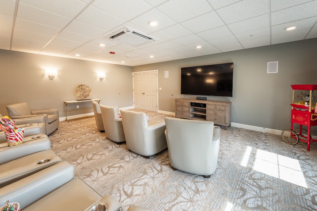 A modern living room with comfortable seating and a large television.