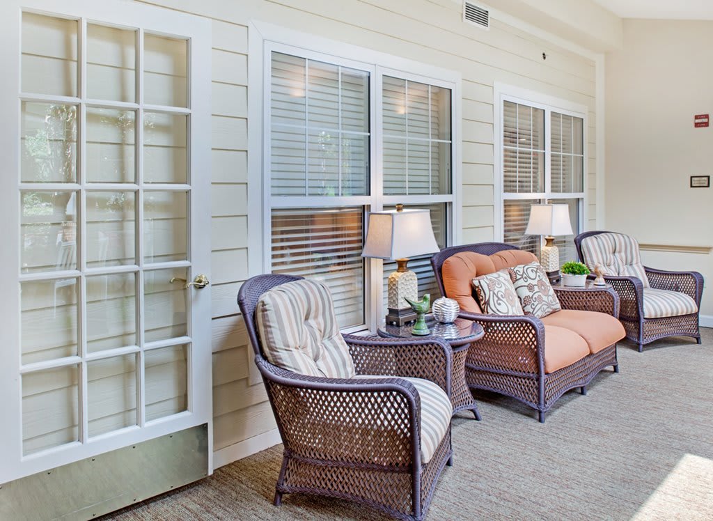 A cozy porch with wicker furniture and decorative lamps, perfect for relaxing.