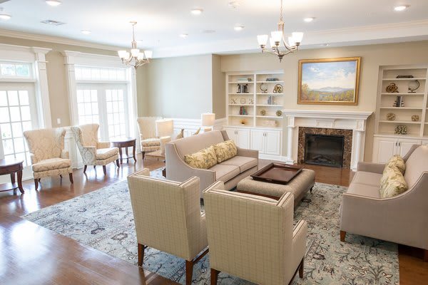 A cozy living room featuring elegant seating, a fireplace, and stylish decor.