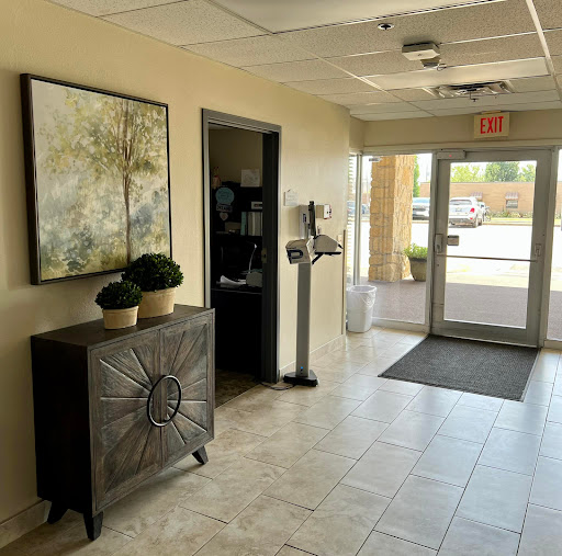Modern lobby area with decorative plants and artwork.