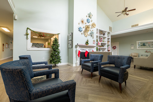 A cozy living room setup featuring stylish chairs, festive decorations, and a touch of greenery.