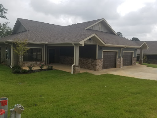 A beautiful single-story house with a well-maintained lawn and multiple garages.