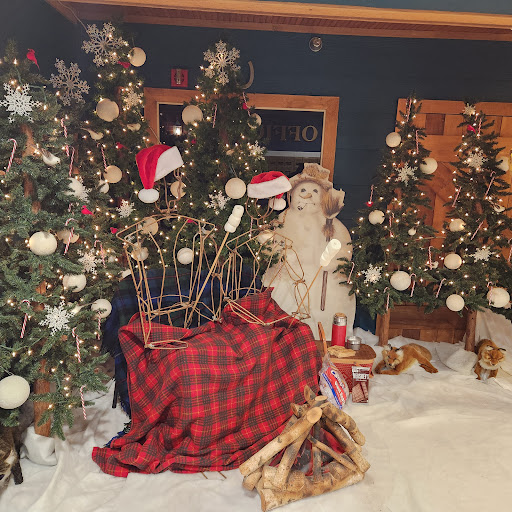 A cozy Christmas scene featuring decorated trees, a festive Santa figure, and holiday ornaments.