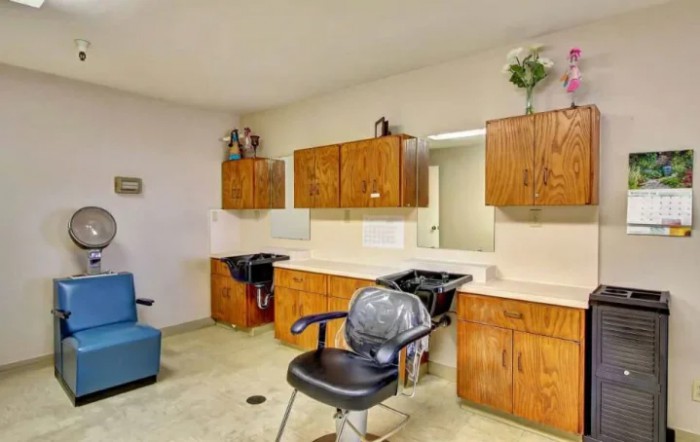 A well-organized hair salon interior with chairs and cabinets.
