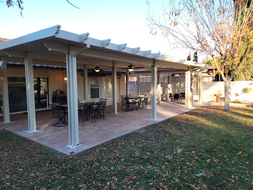 A spacious outdoor patio featuring a pergola and seating, perfect for gatherings.