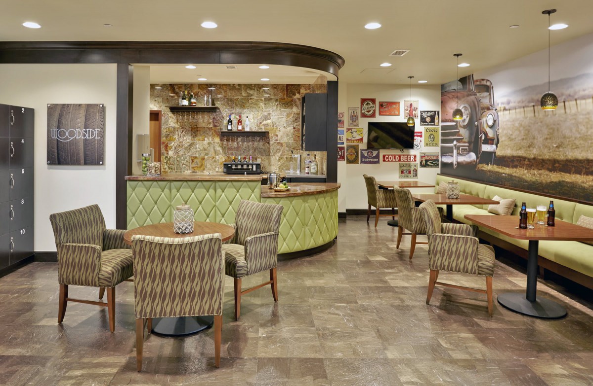 A cozy cafe with modern decor, featuring a bar and seating area.