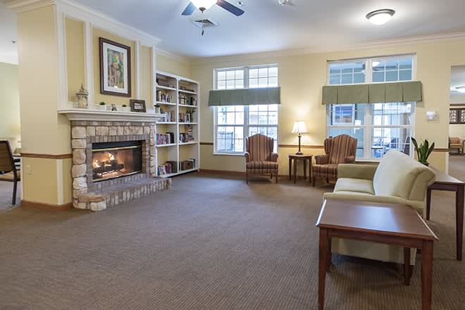 A cozy living room featuring a warm fireplace and comfortable seating.