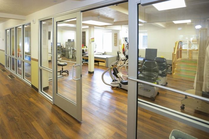 A view into a rehabilitation center with exercise equipment and therapy areas.