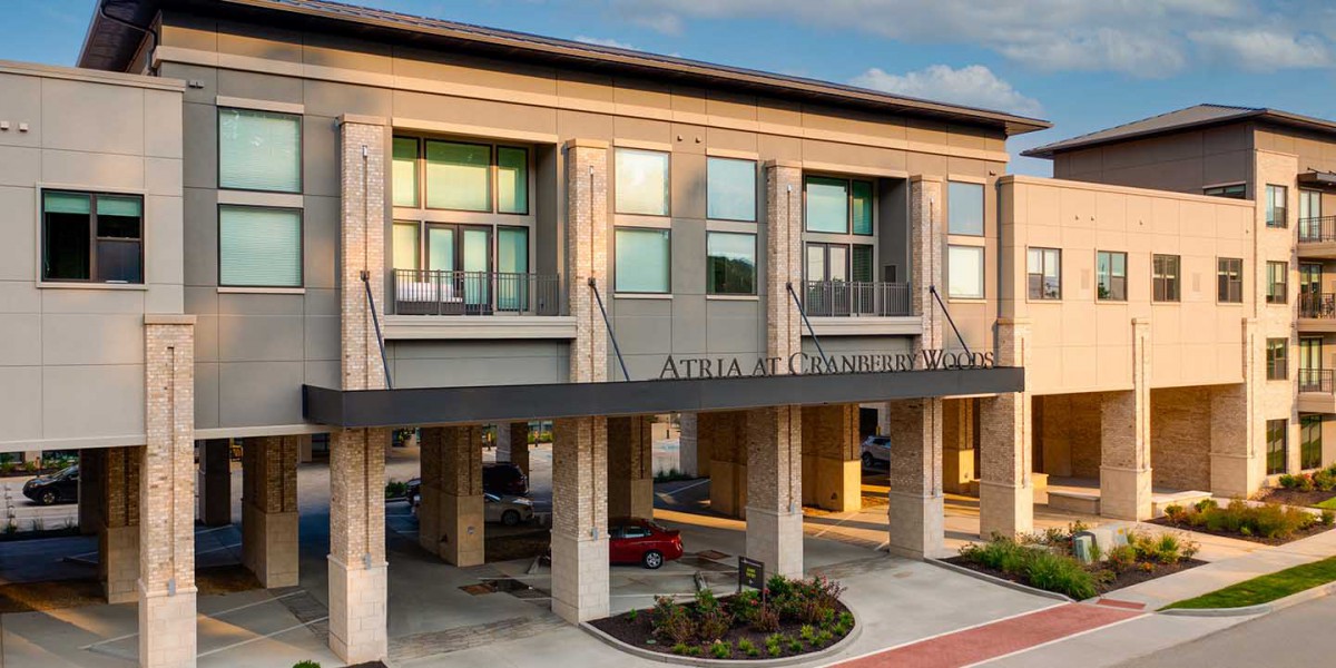 Modern exterior of a multi-story hotel building with large windows.