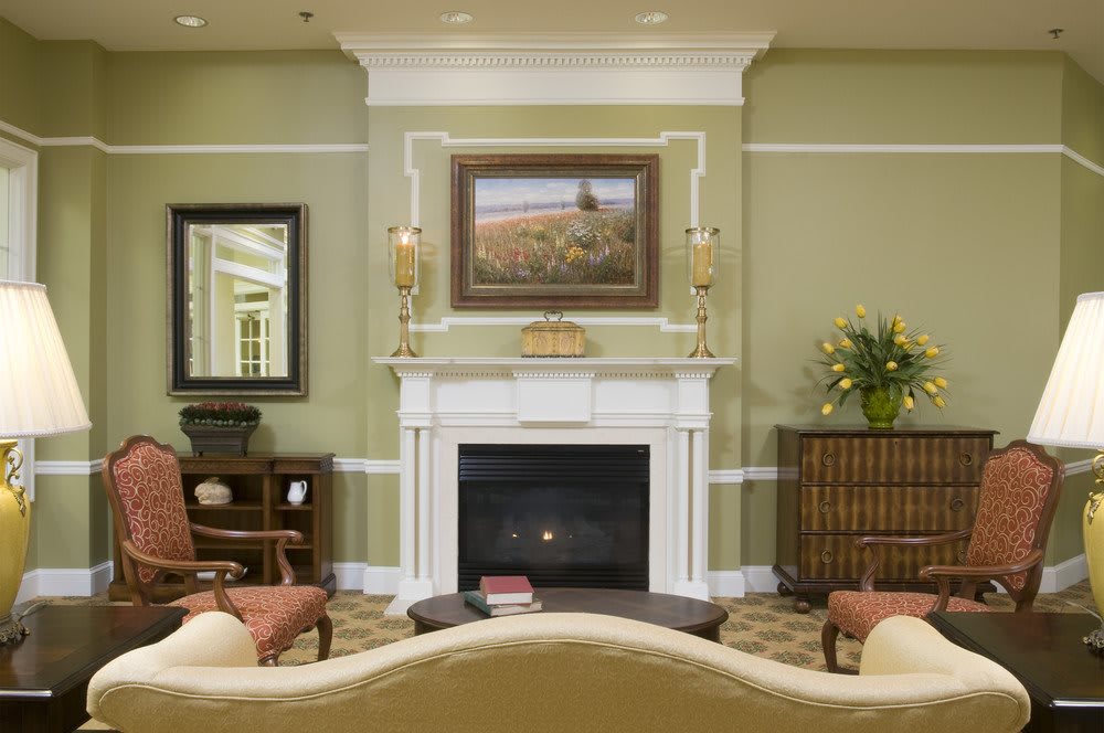 A cozy living room with a central fireplace, adorned with elegant decor.