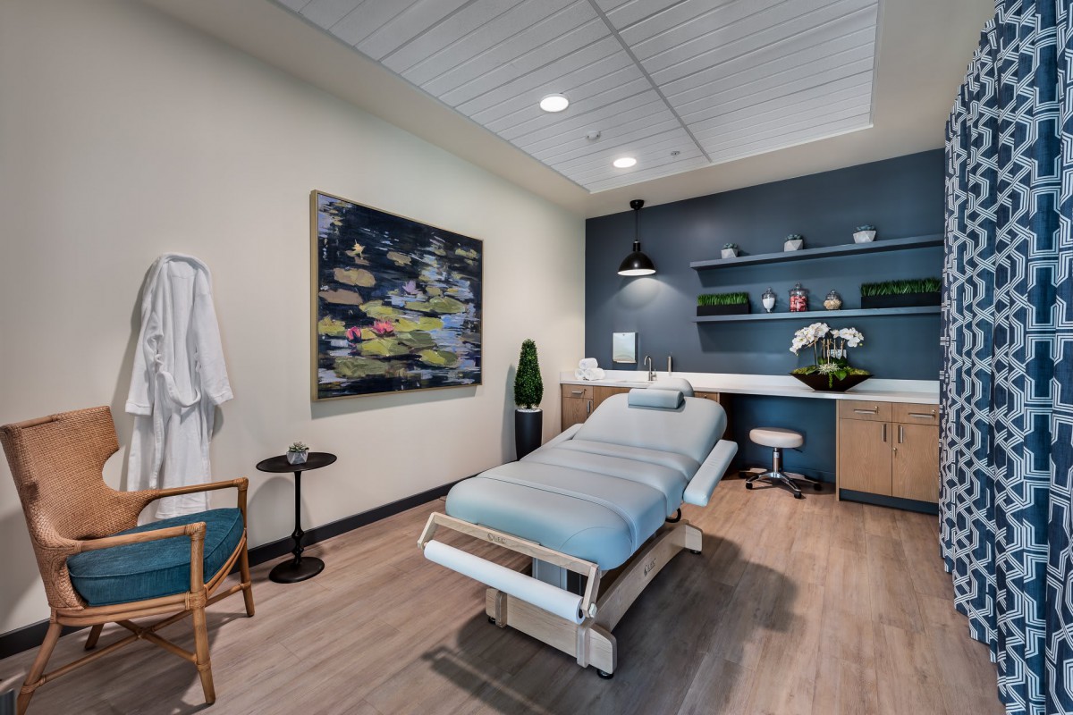 A serene and modern massage room with a treatment table, perfect for relaxation and wellness.