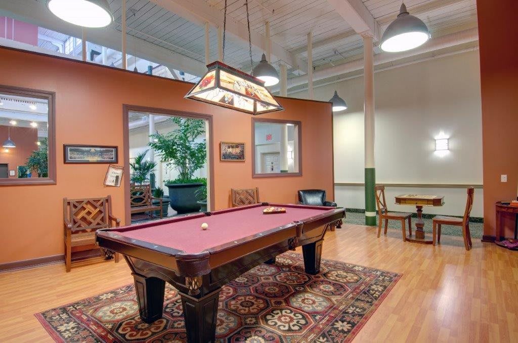 A cozy game room featuring a pool table and stylish decor.