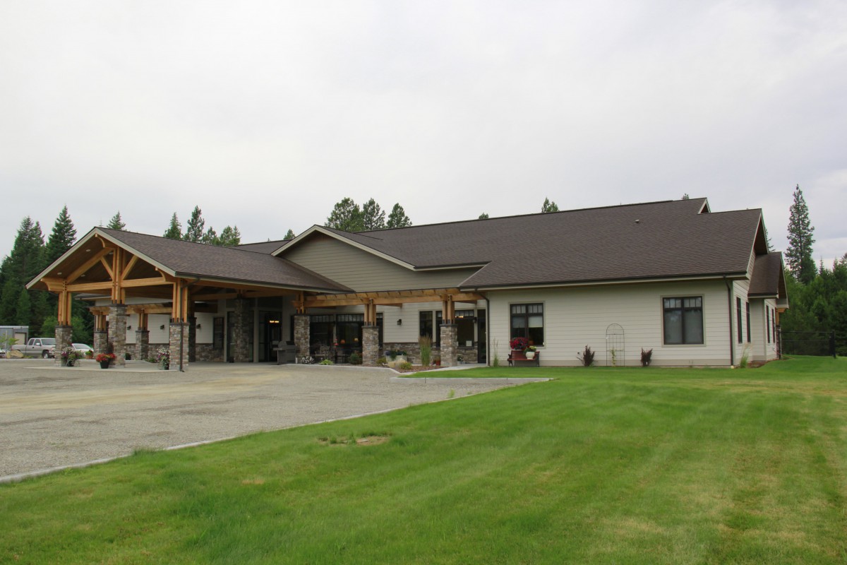 A modern residential building with a well-maintained lawn.
