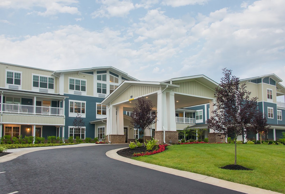 A modern residential building with an inviting entrance and well-maintained landscaping.