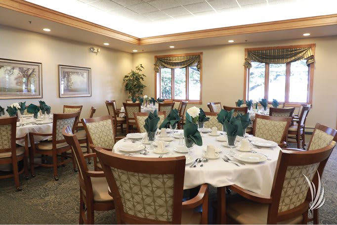 A beautifully set dining room with elegant decor and a formal table arrangement.