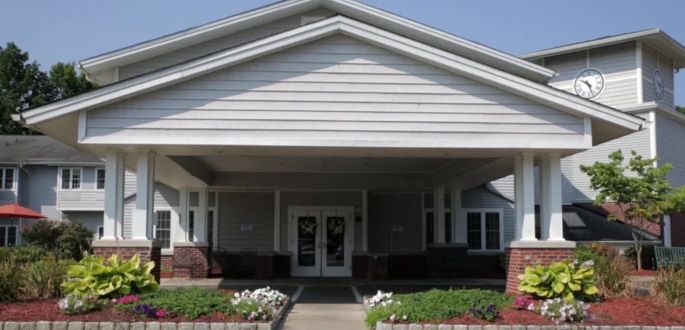 A suburban house entrance with a neatly maintained front yard.