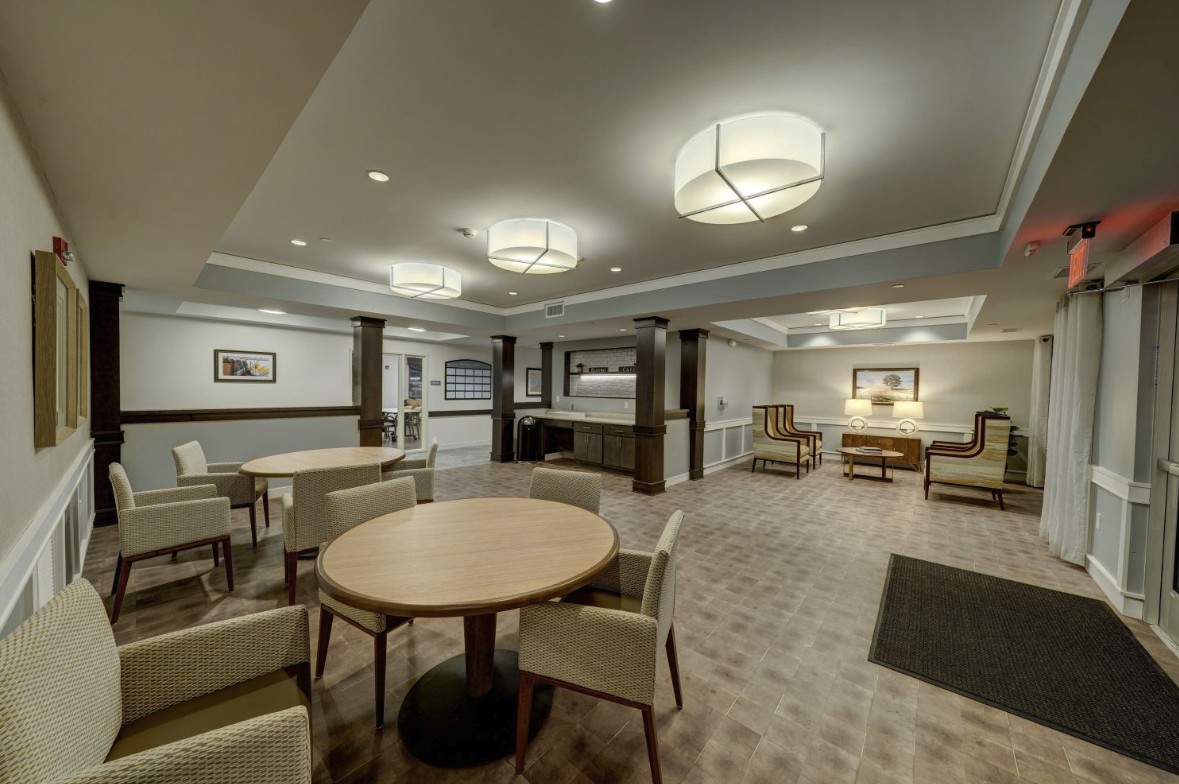 A modern lobby interior with seating areas and soft lighting.