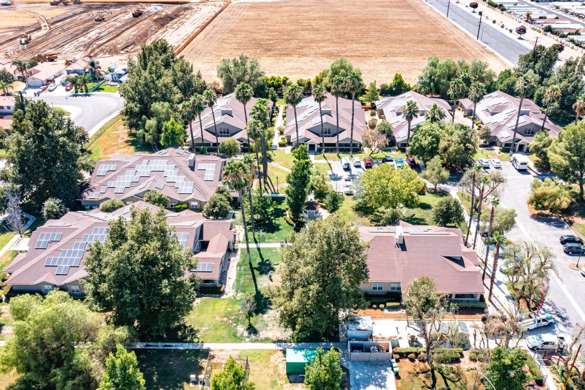 Aerial view of a suburban neighborhood with houses and greenery.