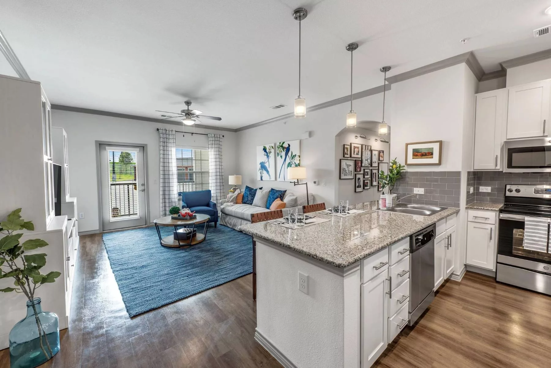 A modern open-concept living room and kitchen with elegant decor and ample natural light.