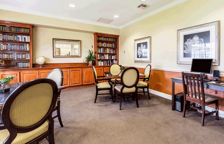 Cozy library seating area with bookshelves and elegant furniture.