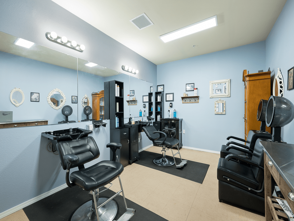 A well-organized hair salon interior with styling chairs and mirrors.