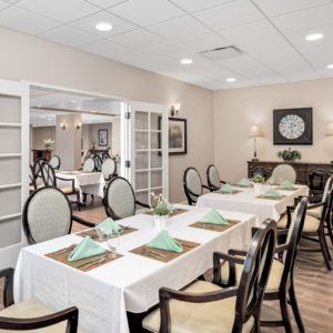 An elegantly decorated dining room with tables set for a formal occasion.