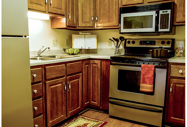 A cozy kitchen with wooden cabinets and stainless steel appliances.