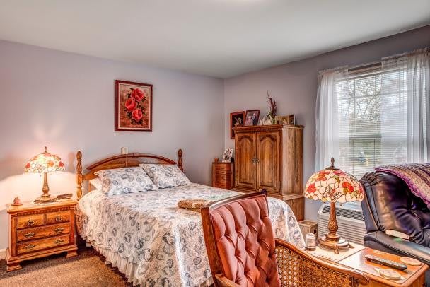 A cozy bedroom with vintage furniture and traditional decor.