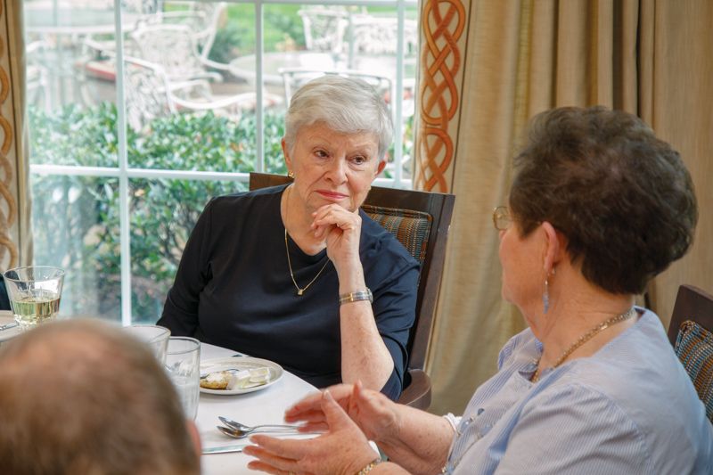Two people engaged in a conversation during a meal.