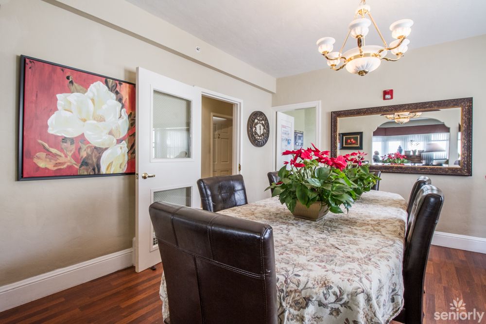 A cozy dining room with a table set and decorative elements.