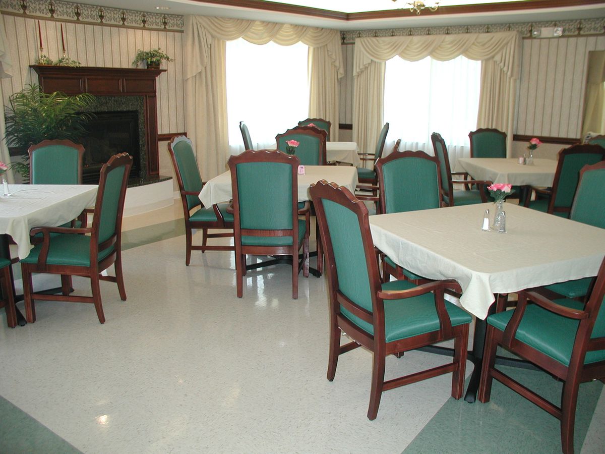 A bright dining room with tables and chairs arranged for seating.