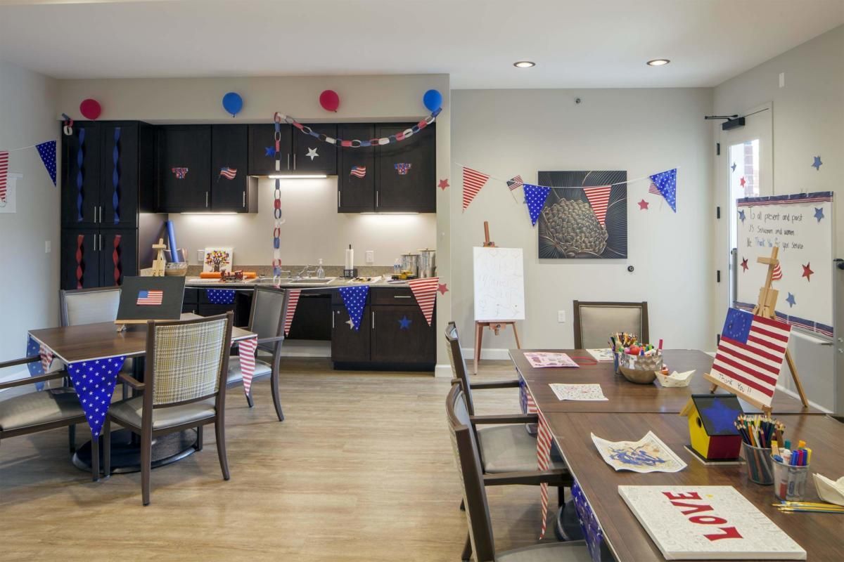 A festive kitchen and dining area decorated with colorful bunting and party elements.