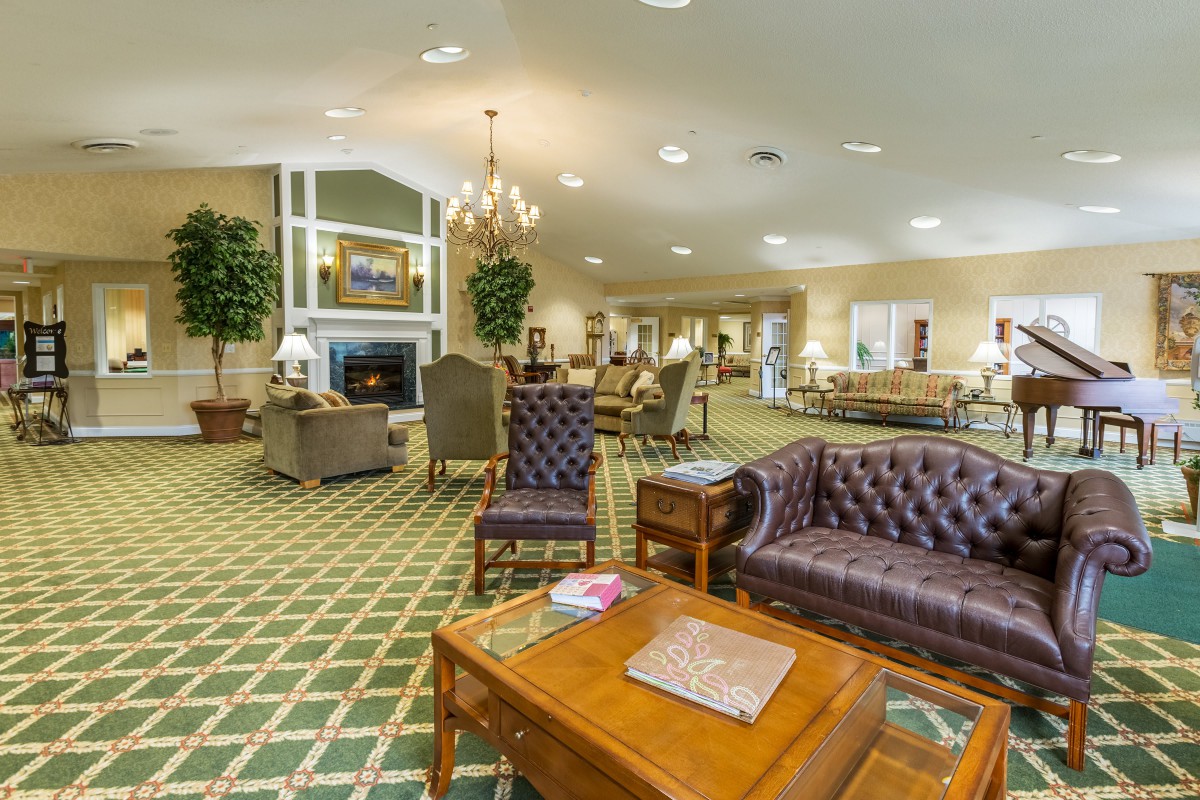 A spacious living room with elegant furniture and a cozy fireplace.