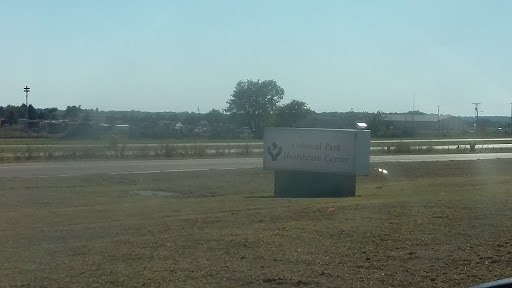 A business sign visible from the highway, indicating a nearby company.
