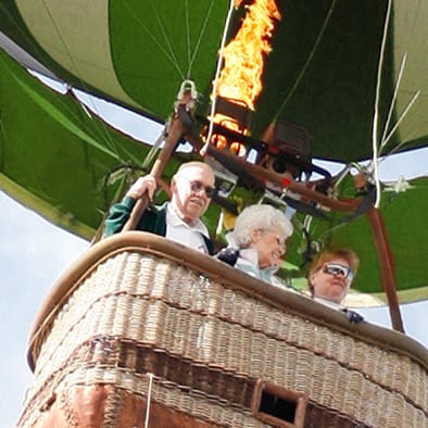 A group of people enjoying a hot air balloon ride.