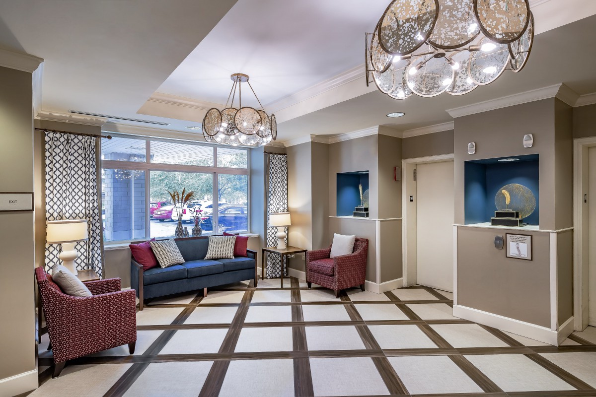 A stylish and modern lobby with elegant chandeliers and comfortable seating.