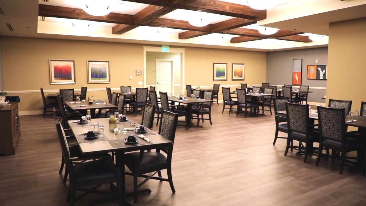 An empty restaurant dining area with neatly arranged tables and chairs.