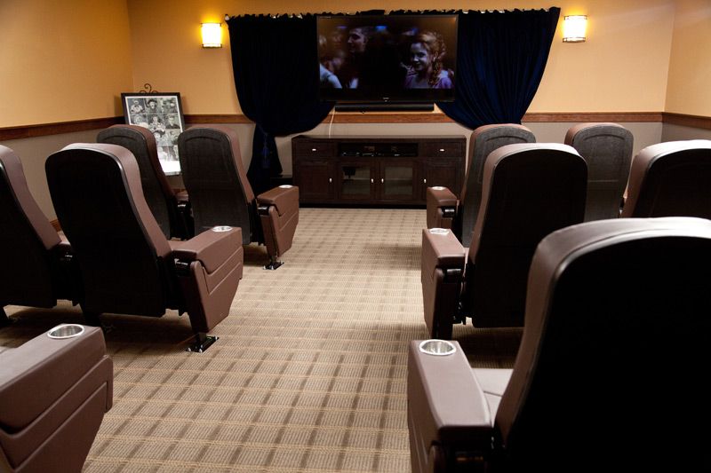A cozy home theater setup with comfortable seating and a large screen.