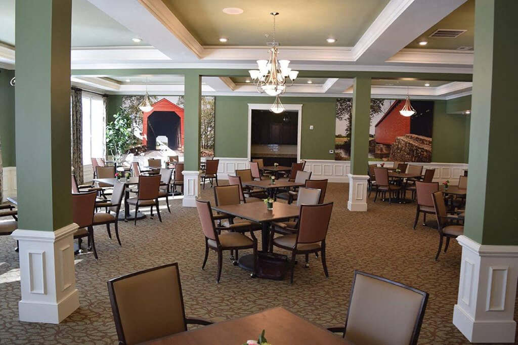 An elegantly decorated dining room with tables and chairs neatly arranged.