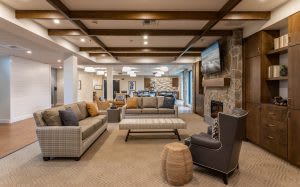 A spacious and modern living room with comfortable seating and a cozy fireplace.