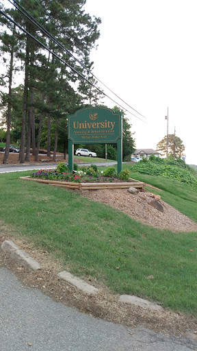A welcoming sign marking the entrance to a university campus.