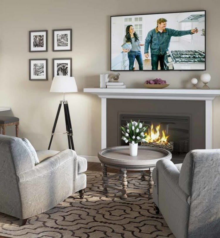 A cozy living room with a fireplace and modern furnishings, featuring a TV mounted above the mantel.