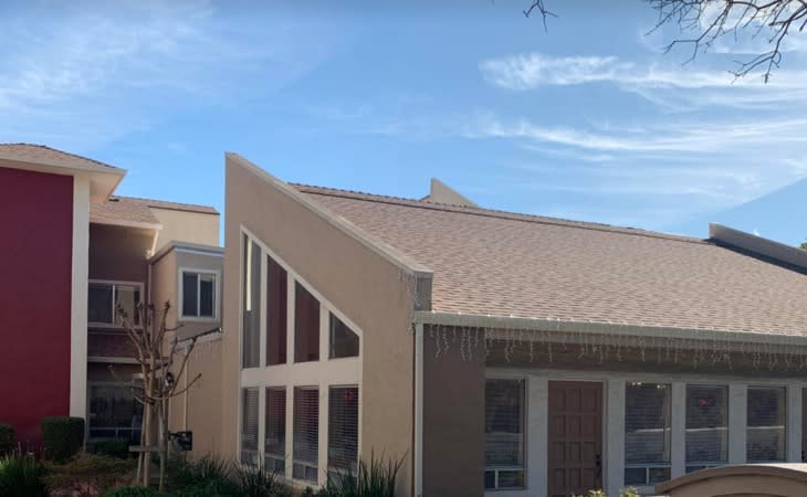 A modern building with a unique roof design and large windows.