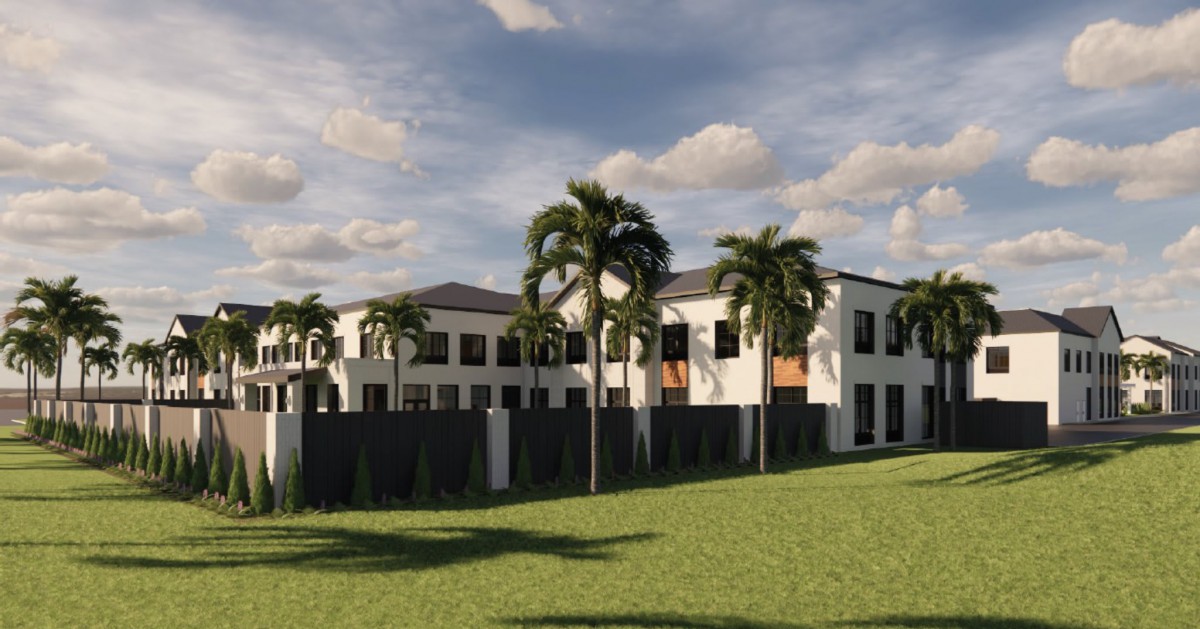 A modern residential building surrounded by palm trees on a sunny day.